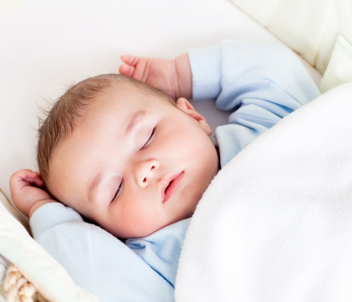 3674881-portrait-of-a-peaceful-baby-sleeping-in-his-cradle-at-home